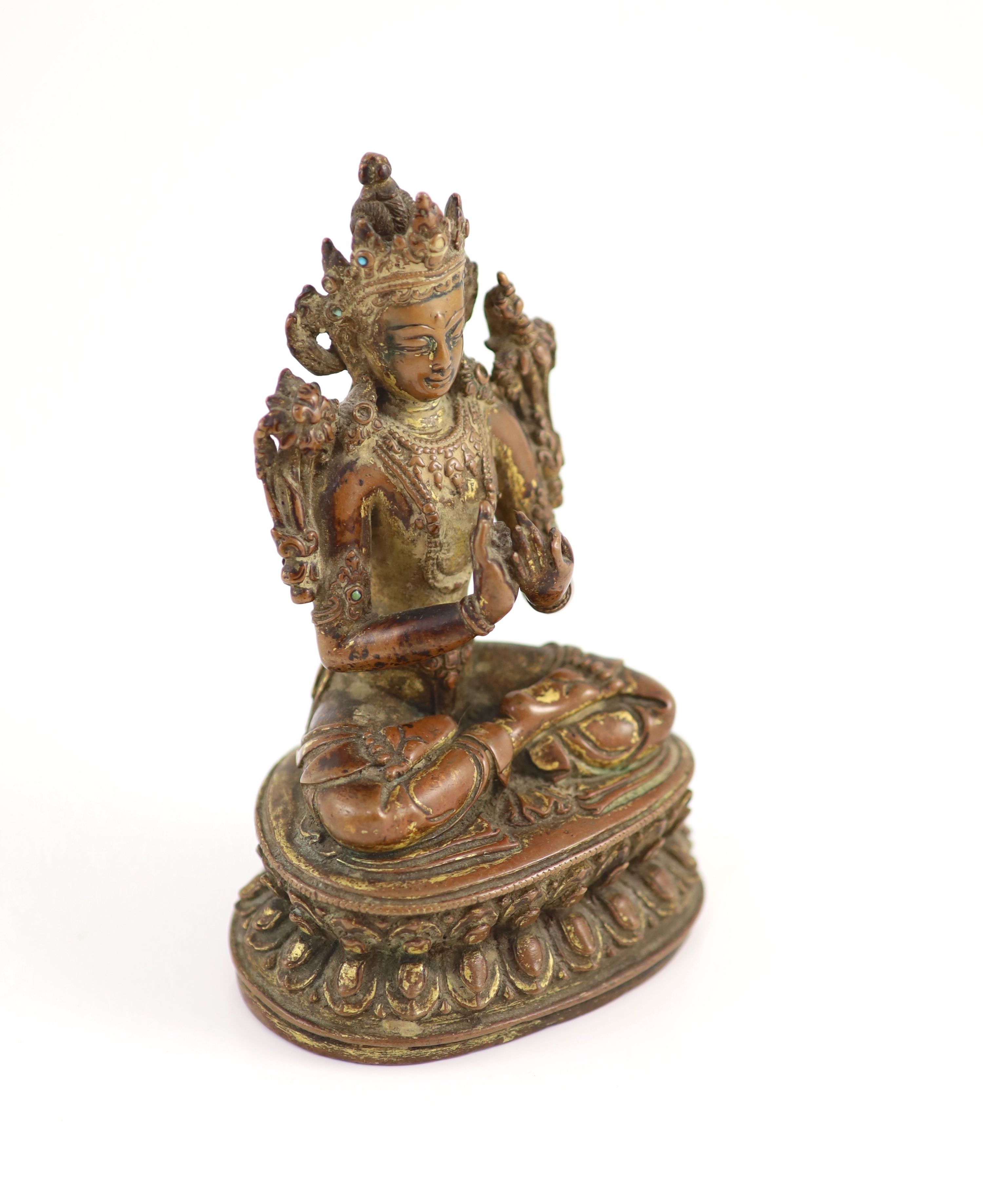 A Tibetan gilt copper alloy figure of Maitreya, 17th/18th century, 14.8cm high, worn